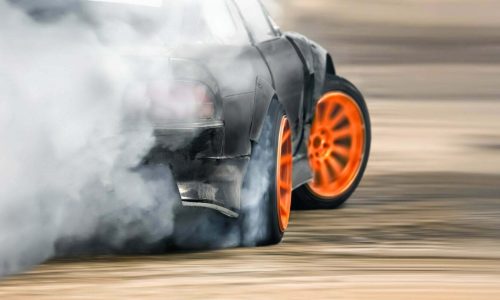 Race drift car burning tires on speed track